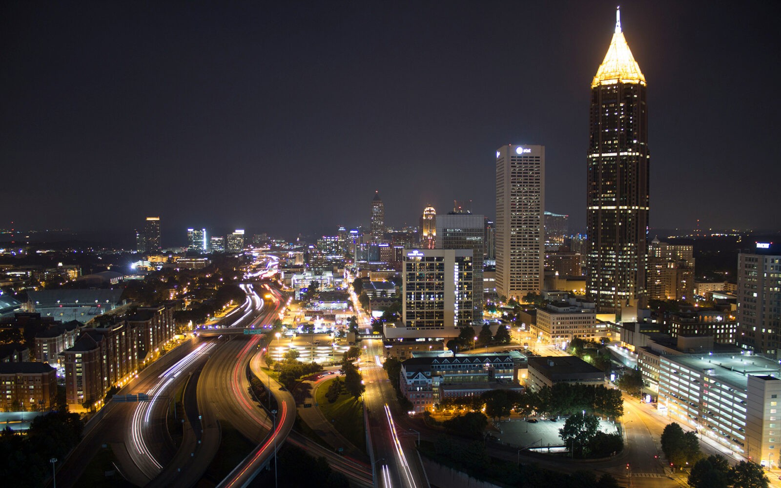 CloudMasonry - Georgia Based Salesforce Consulting - Atlanta Office Landing Page Image - Atlanta skyline at night with illuminated buildings.