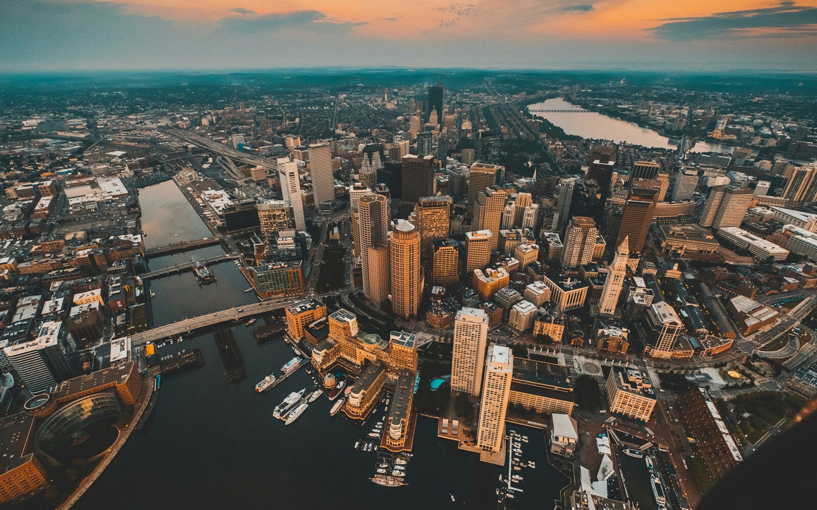 CloudMasonry - Massachusetts Based Salesforce Consulting - Boston Office Landing Page Image - Aerial view of city skyline at sunset.