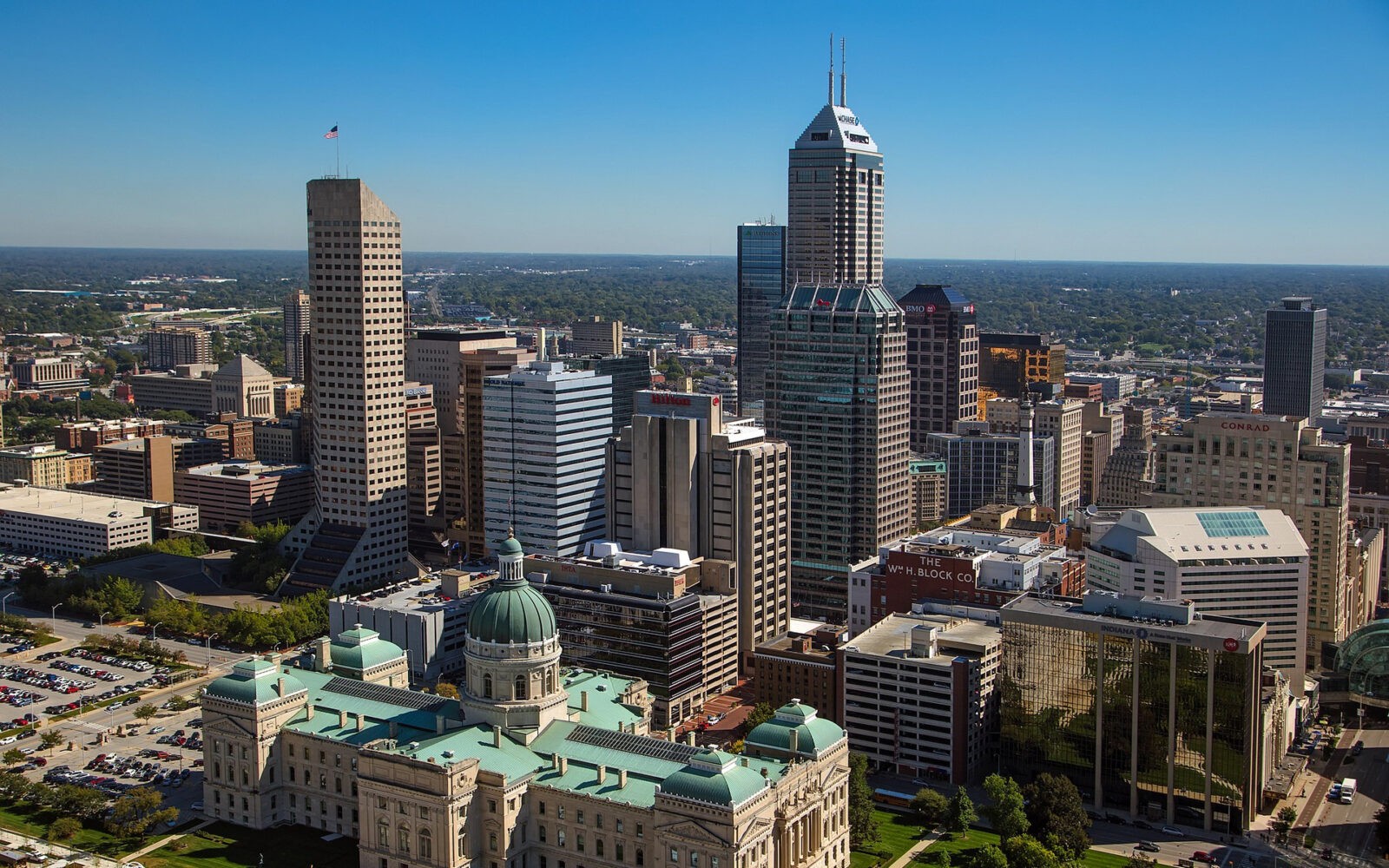 CloudMasonry - Indiana Based Salesforce Consulting - Indianapolis Salesforce Tower Corporate Headquarters Landing Page Image -Indianapolis skyline with tall buildings and green domes.